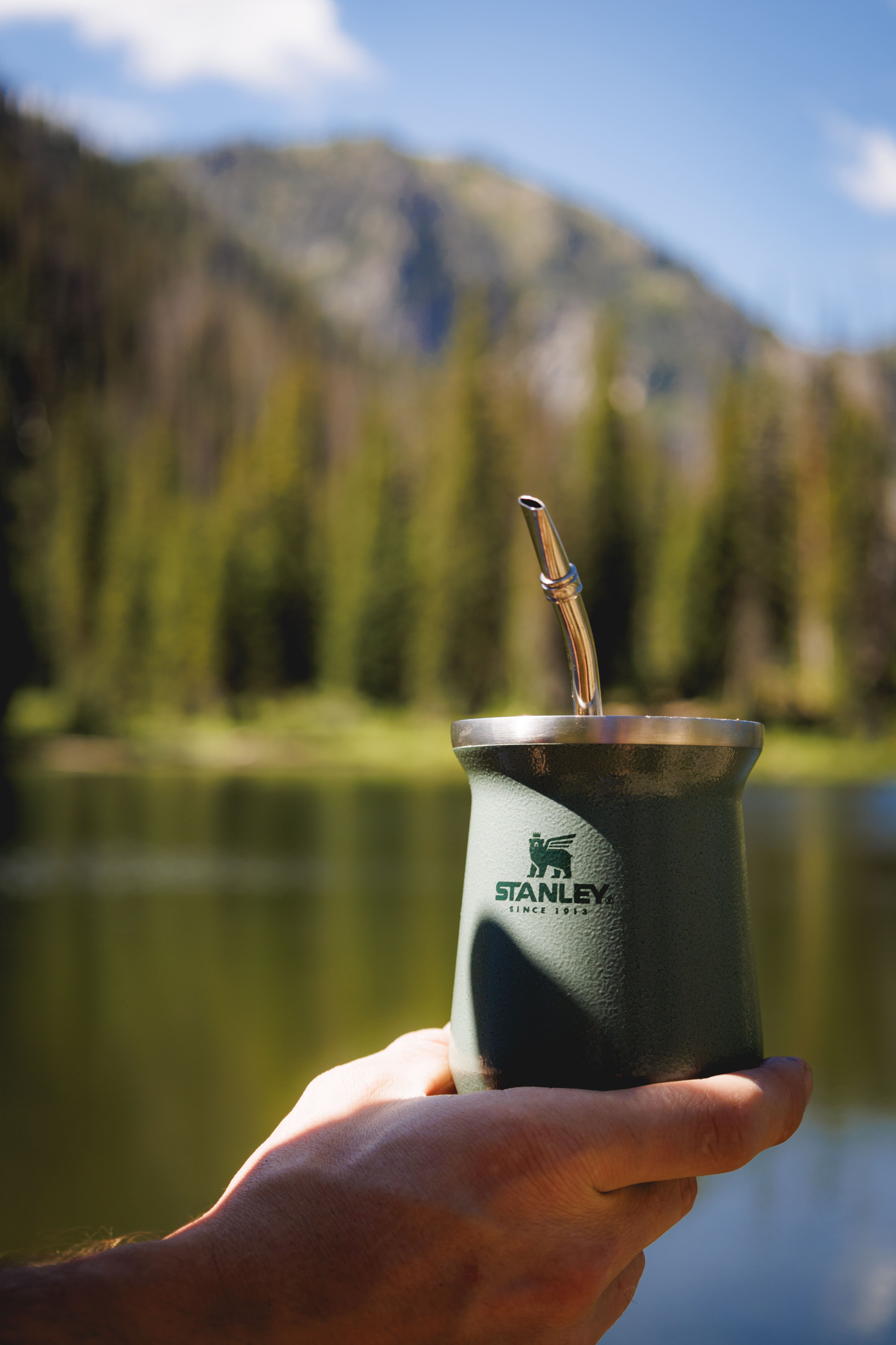 hand holding an aluminum cup