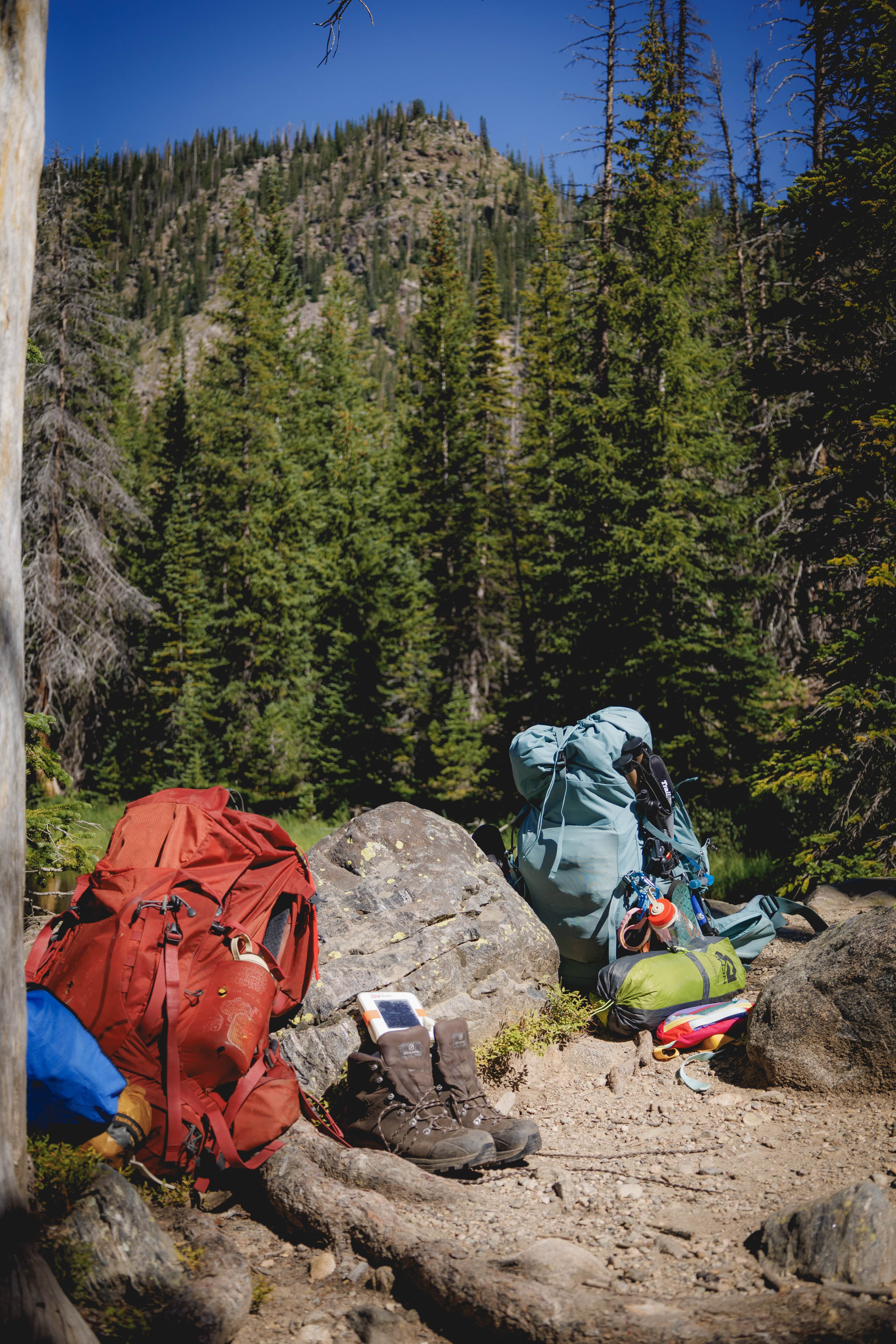backpacks and hiking gear on rocks